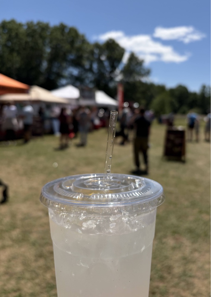 Lemonade from Euro Delicacies with farmers market vendors and customers in the background 