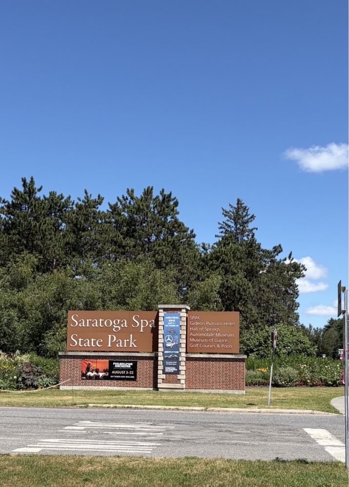 Saratoga Spa State Park entrance sign against the blue sky near the Spa City Farmers' Market